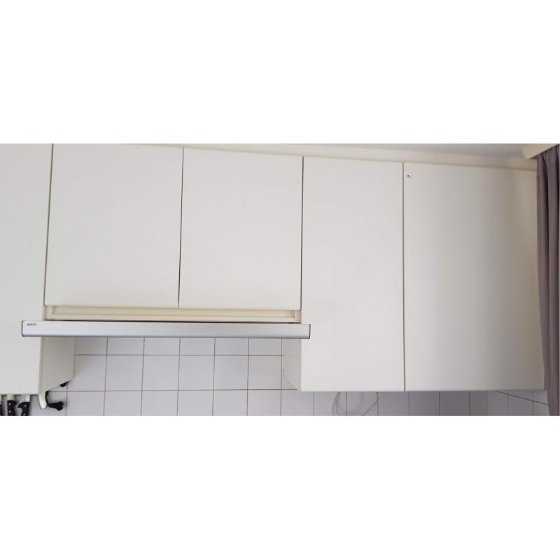 Een ingebouwde keuken greeploos uitgevoerd in witte laminaat in u-vorm